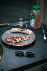 Witte pens op de BBQ met mayonaise, ketchup en gefrituurde uitjes